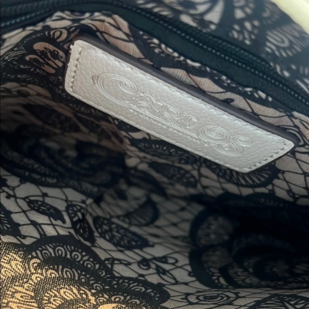 Carlos Santana White Textured Wristlet with Zipper Closure and rose medal accent